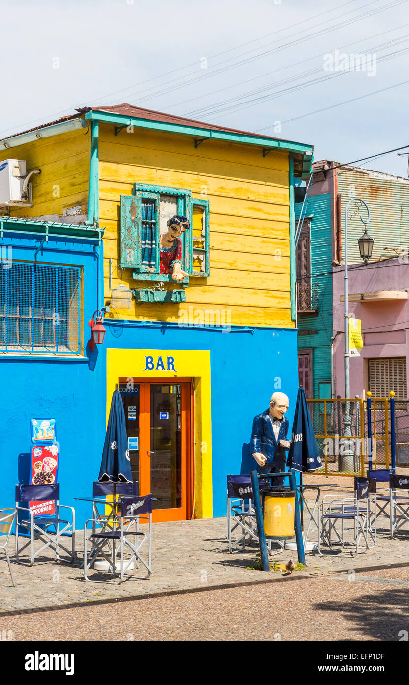 Colourful bar building in La Boca, Buenos Aires, Argentina with effigies of a butler outside and a woman leaning out of a window Stock Photo