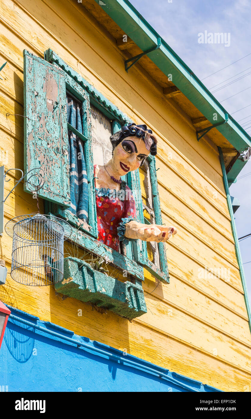Colourful effigy of a local woman in hair curlers leaning out of a window in La Boca, Buenos Aires, Argentina Stock Photo