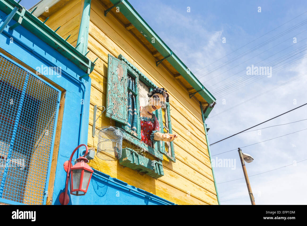 Colourful effigy of a local woman in hair curlers leaning out of a window in La Boca, Buenos Aires, Argentina Stock Photo