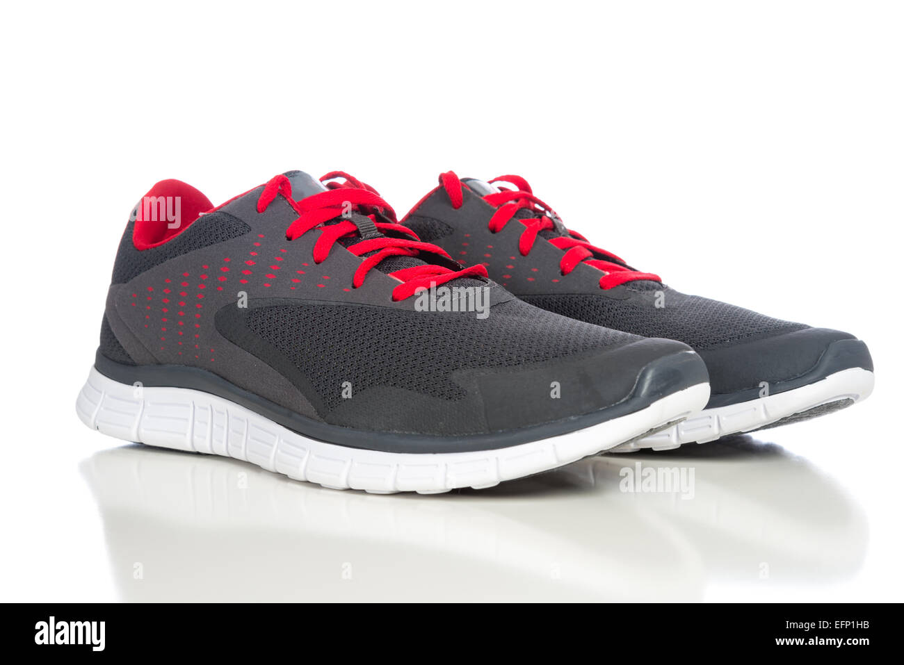 Gray athletic shoes with red shoe laces Stock Photo - Alamy