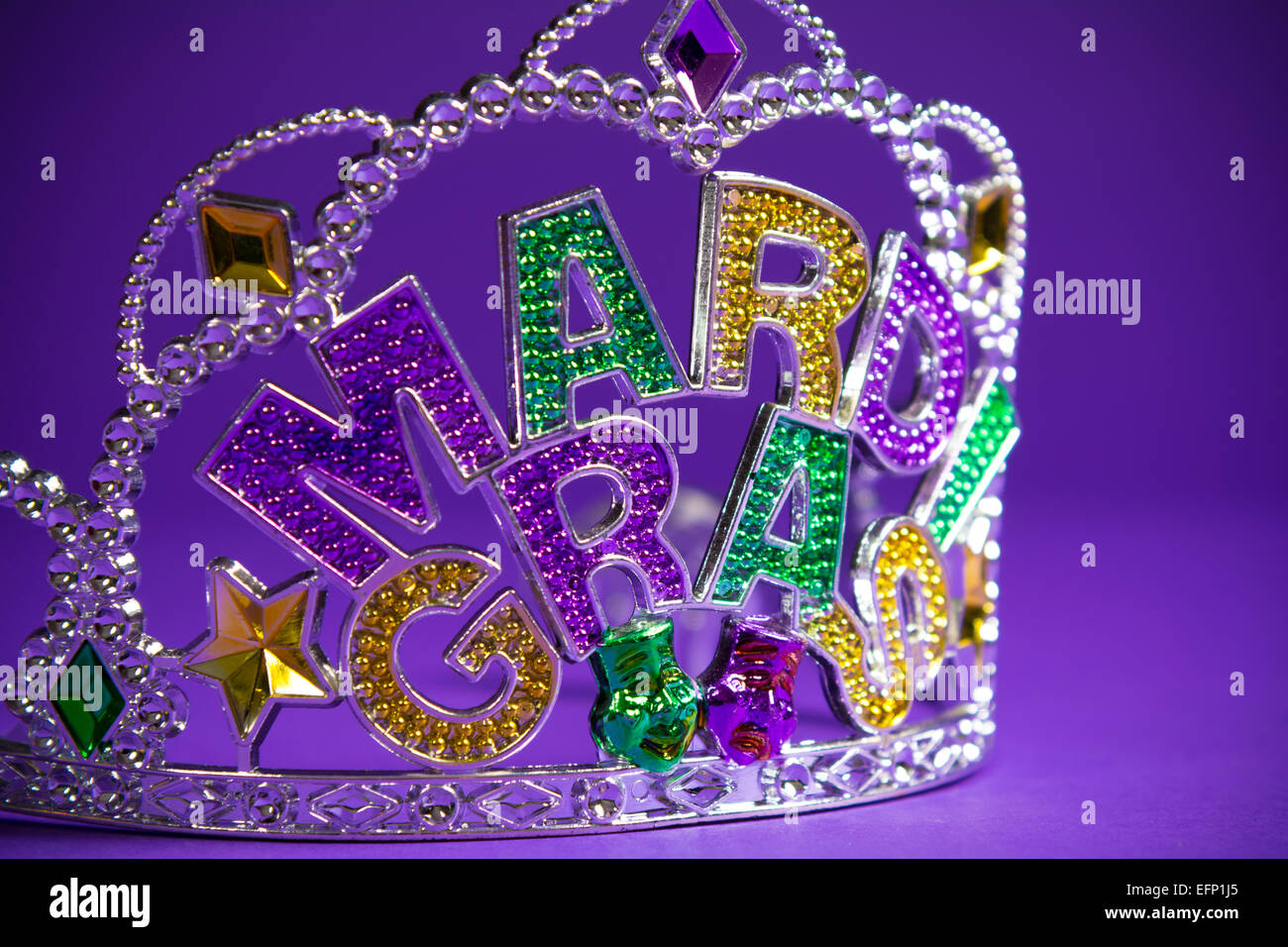 A colorful mardi gras crown on a purple background Stock Photo - Alamy