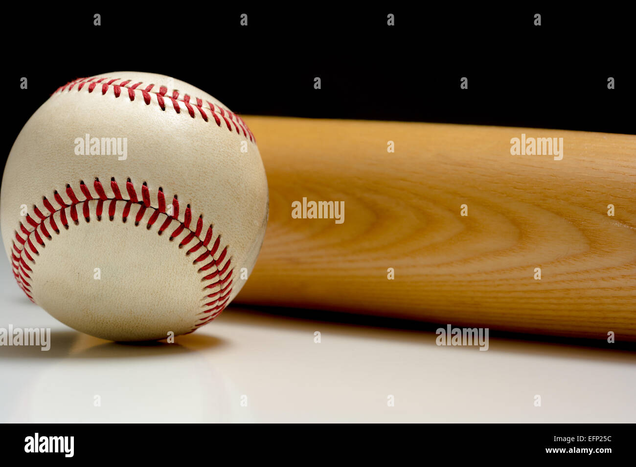 A wooden baseball bat and ball Stock Photo