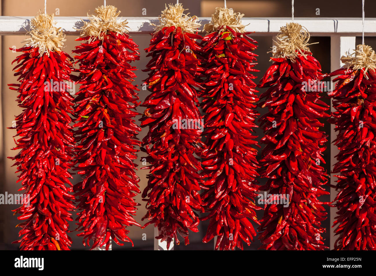 Red, ristra hanging chili peppers as a background Stock Photo