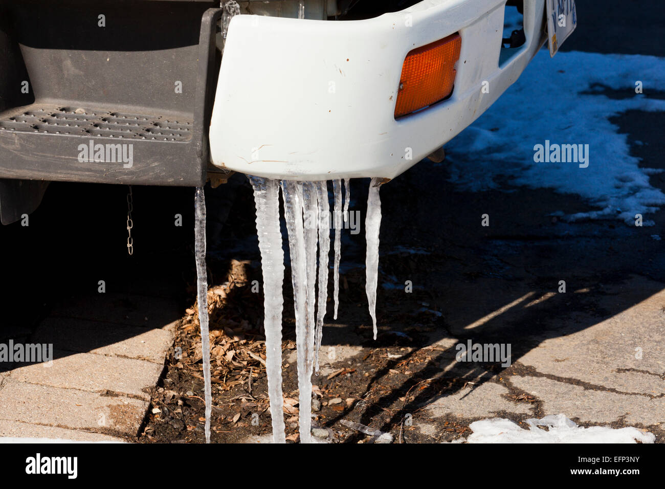 Icicles hanging from car bumper - USA Stock Photo