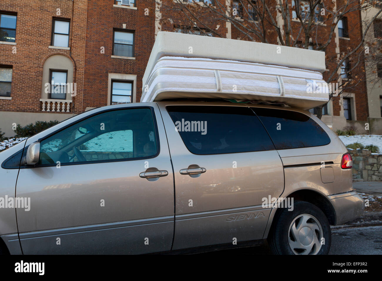 Bed mattresses on top of minivan - USA Stock Photo