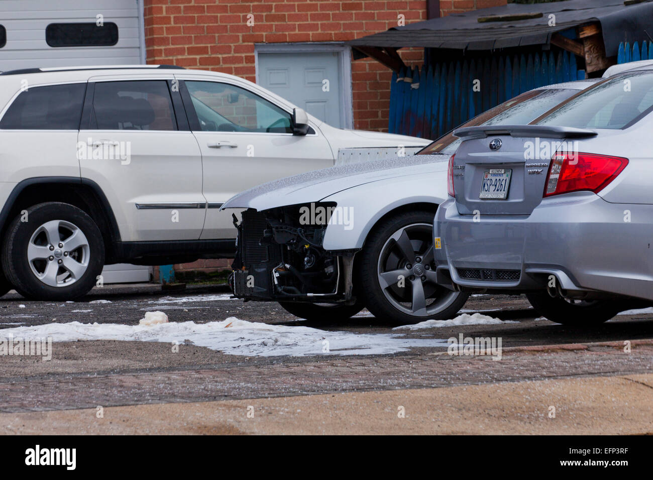 Car with front end collision damage at auto body repair shop - USA Stock Photo