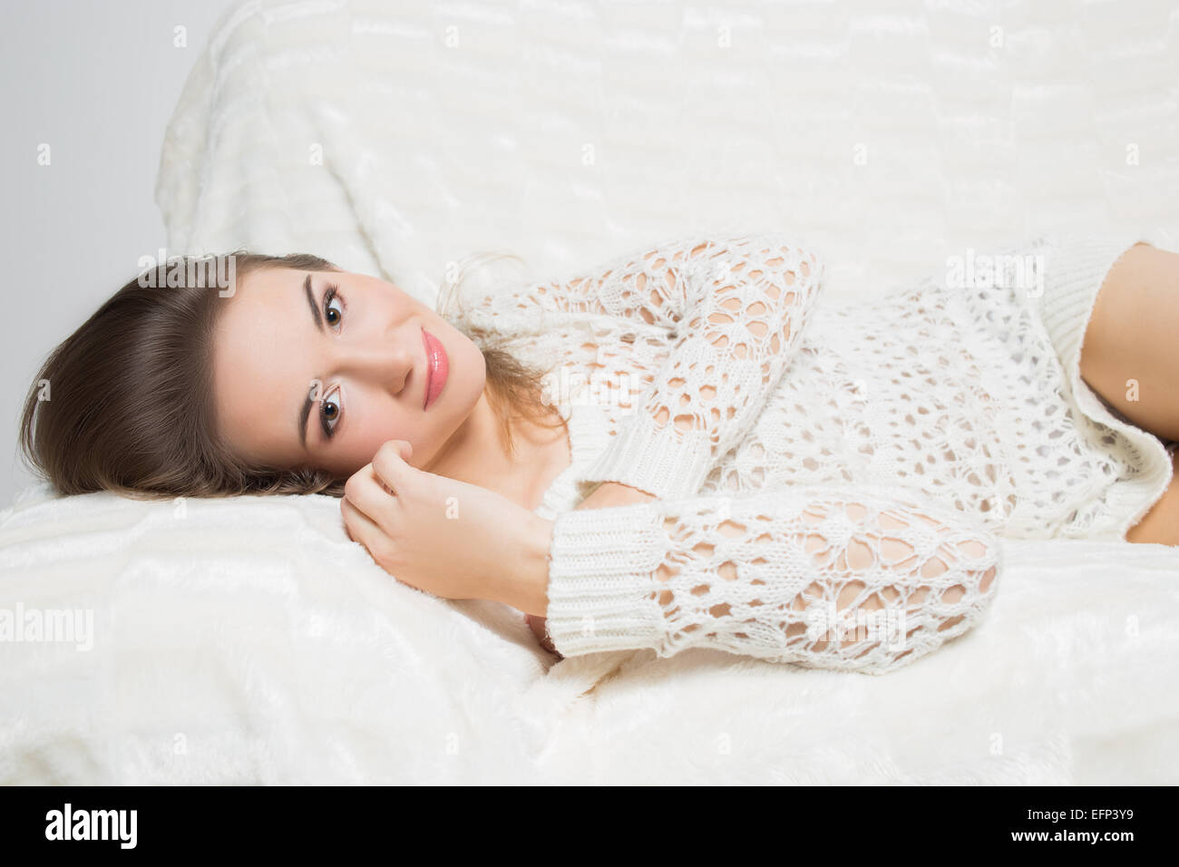 smiling girl sitting on sofa Stock Photo - Alamy