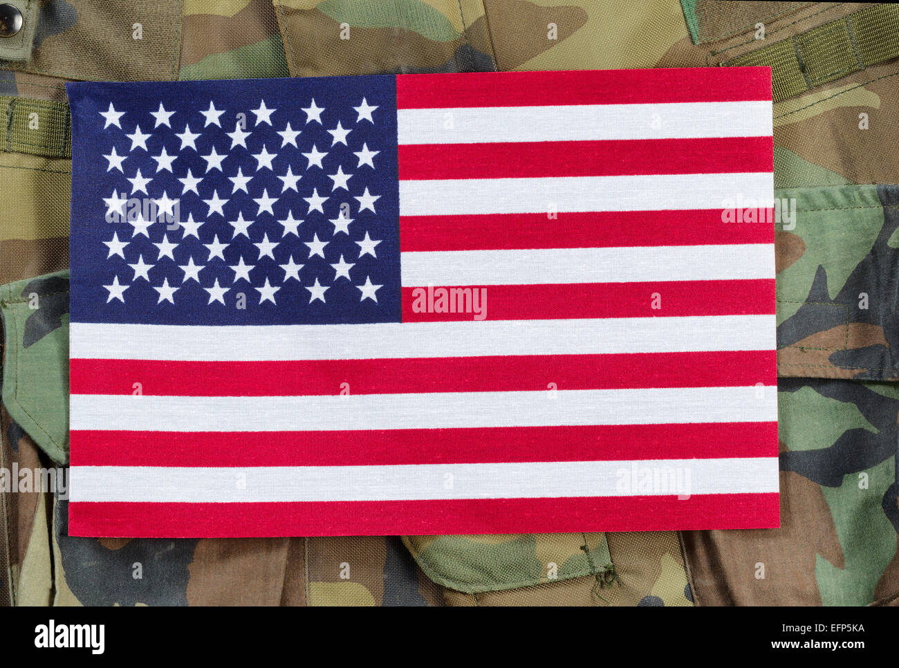 Top view angled shot of United States flag with military uniform background. Stock Photo