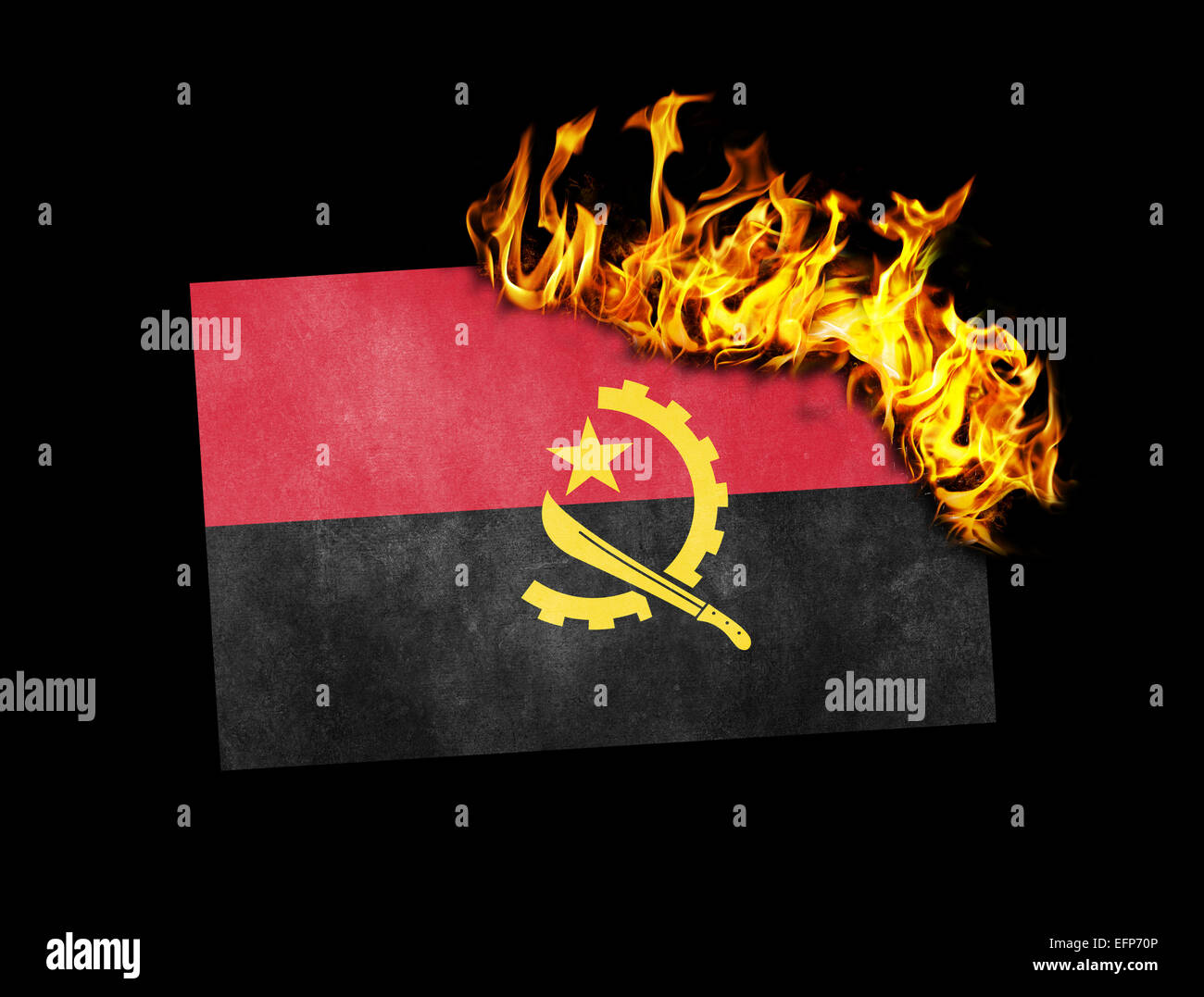 Flag burning - concept of war or crisis - Angola Stock Photo