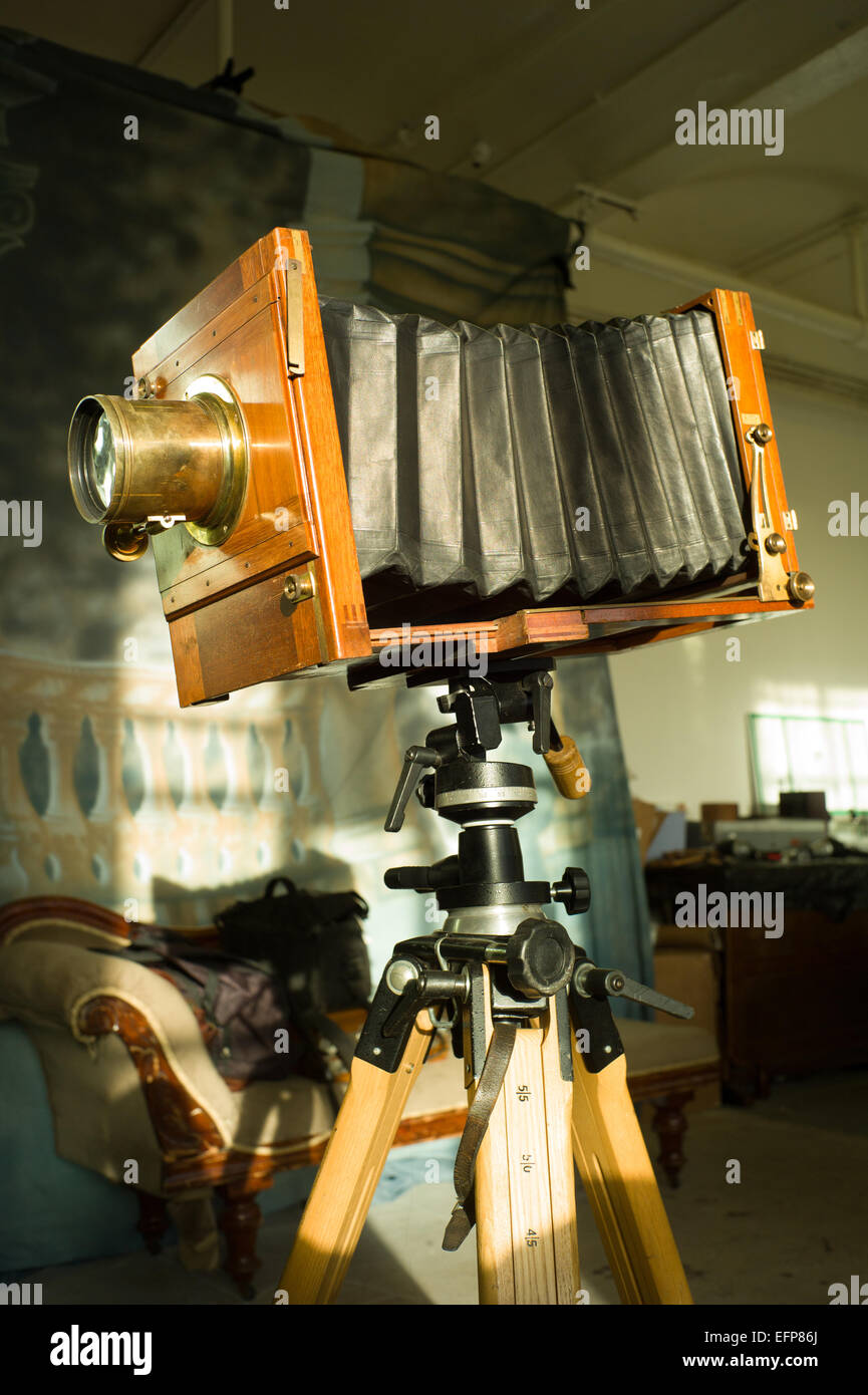 Old fashioned 10x8 glass plate camera complete with Petzval lens, mounted on a tripod. Stock Photo