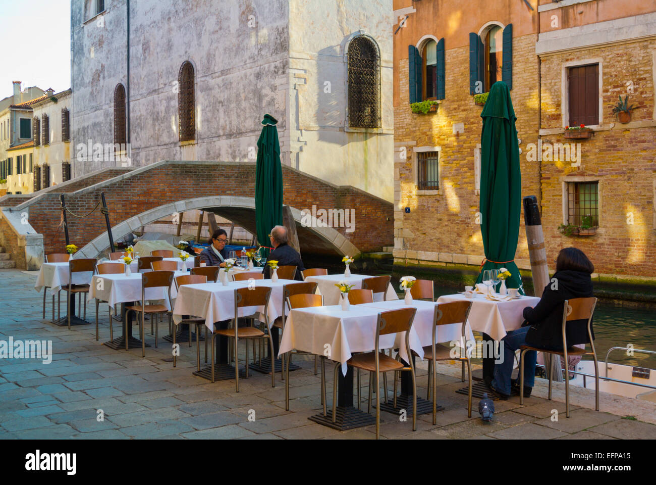 Restaurant terrace by a canal, Cannaregio district, Venice, Italy Stock Photo