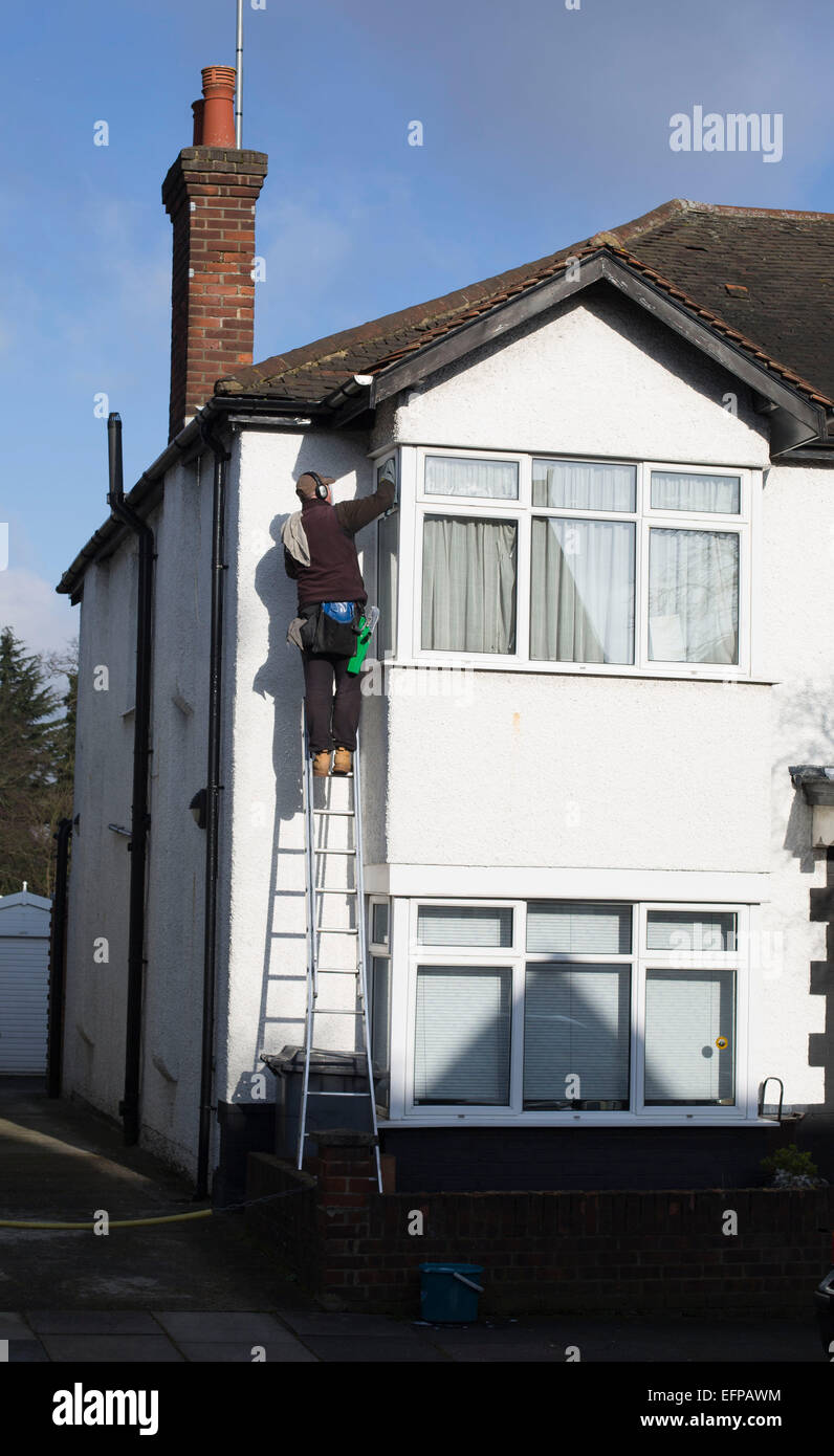 Window cleaner up ladder cleaning washing windows Stock Photo Alamy