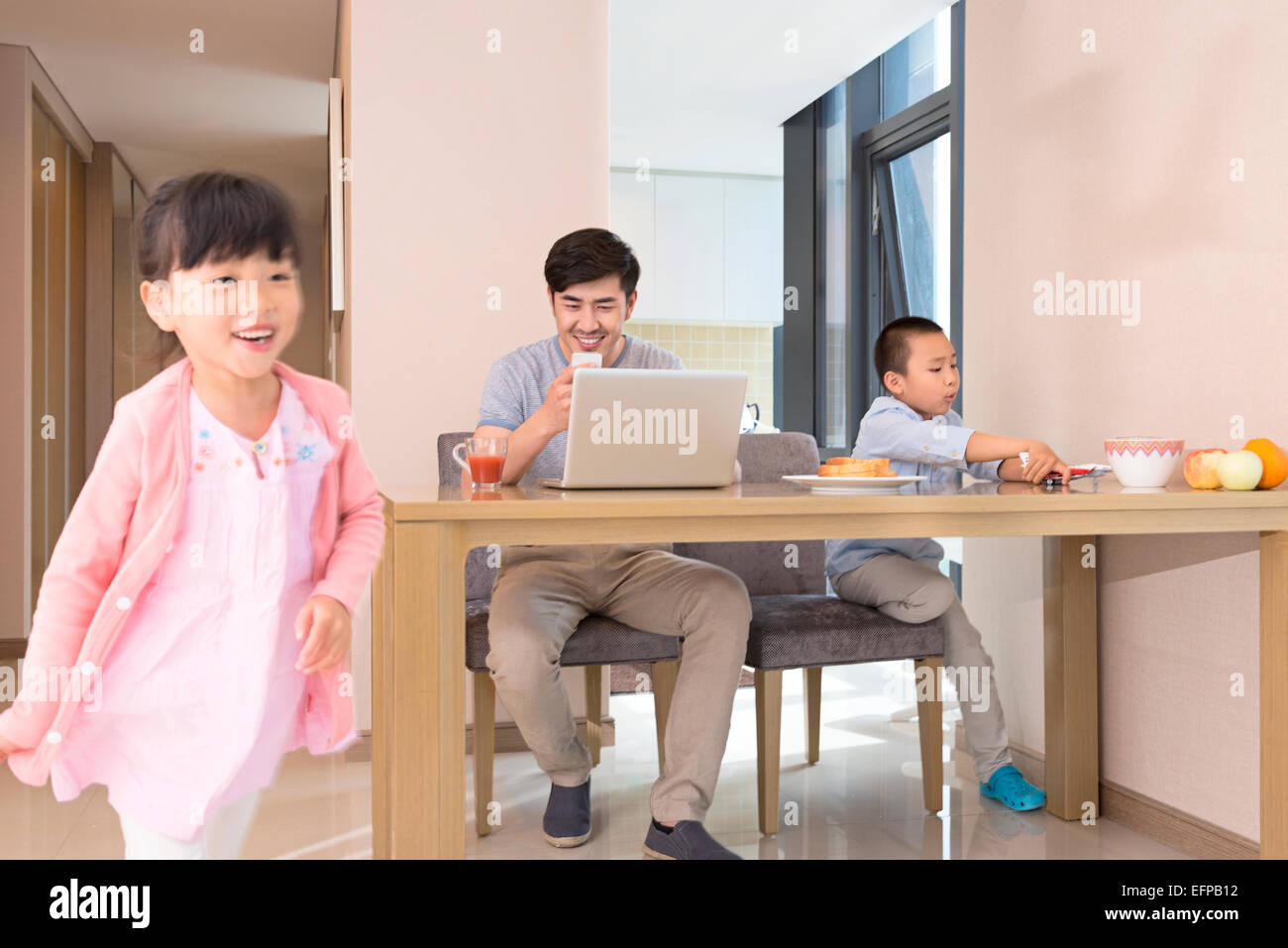 Father working at home with children Stock Photo