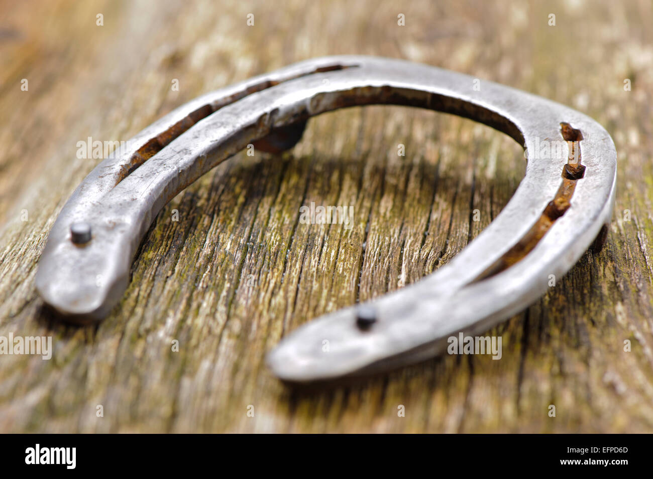 old horseshoe on wood Stock Photo