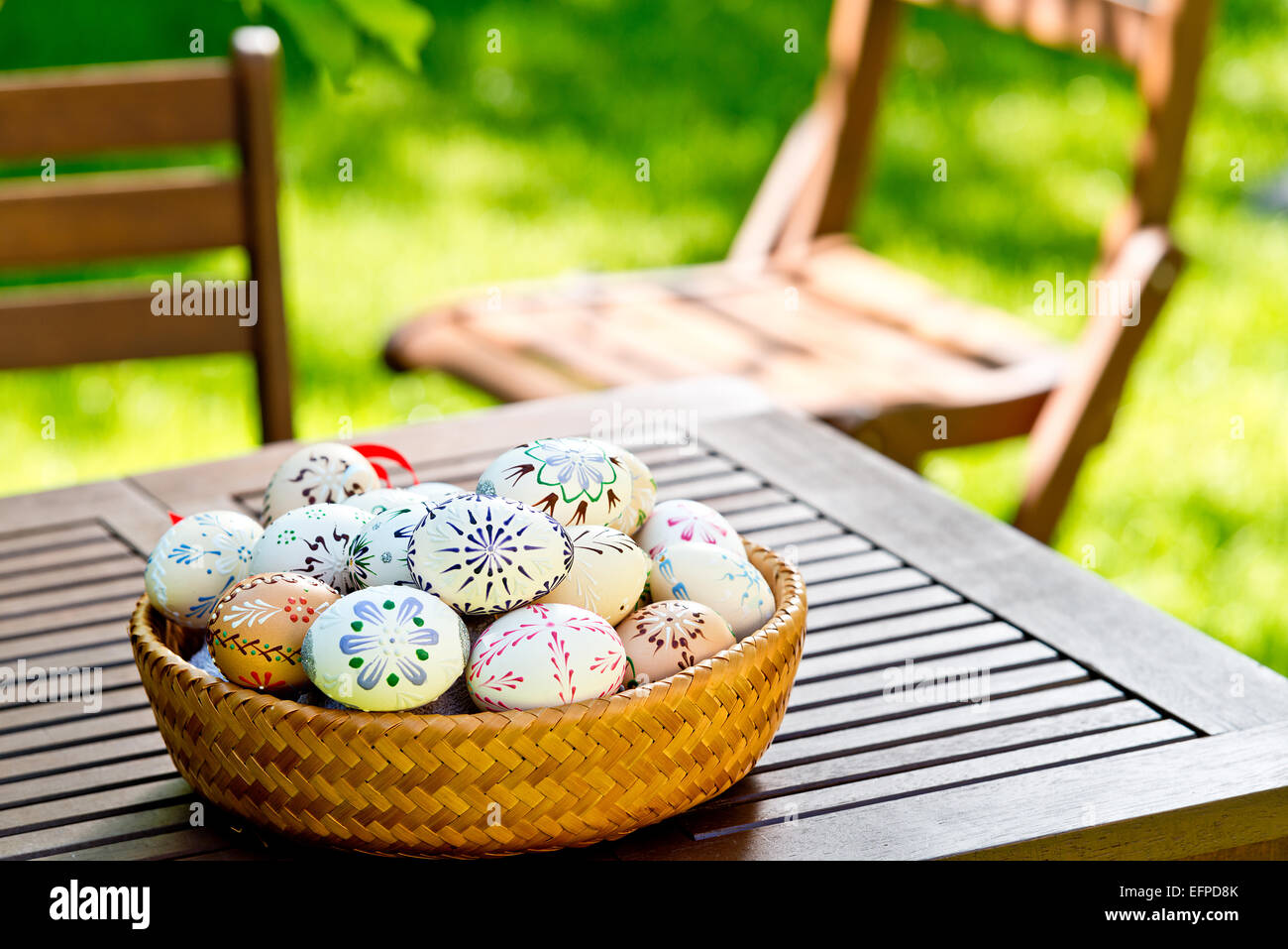 Colored Easter eggs on the desk in the garden Stock Photo