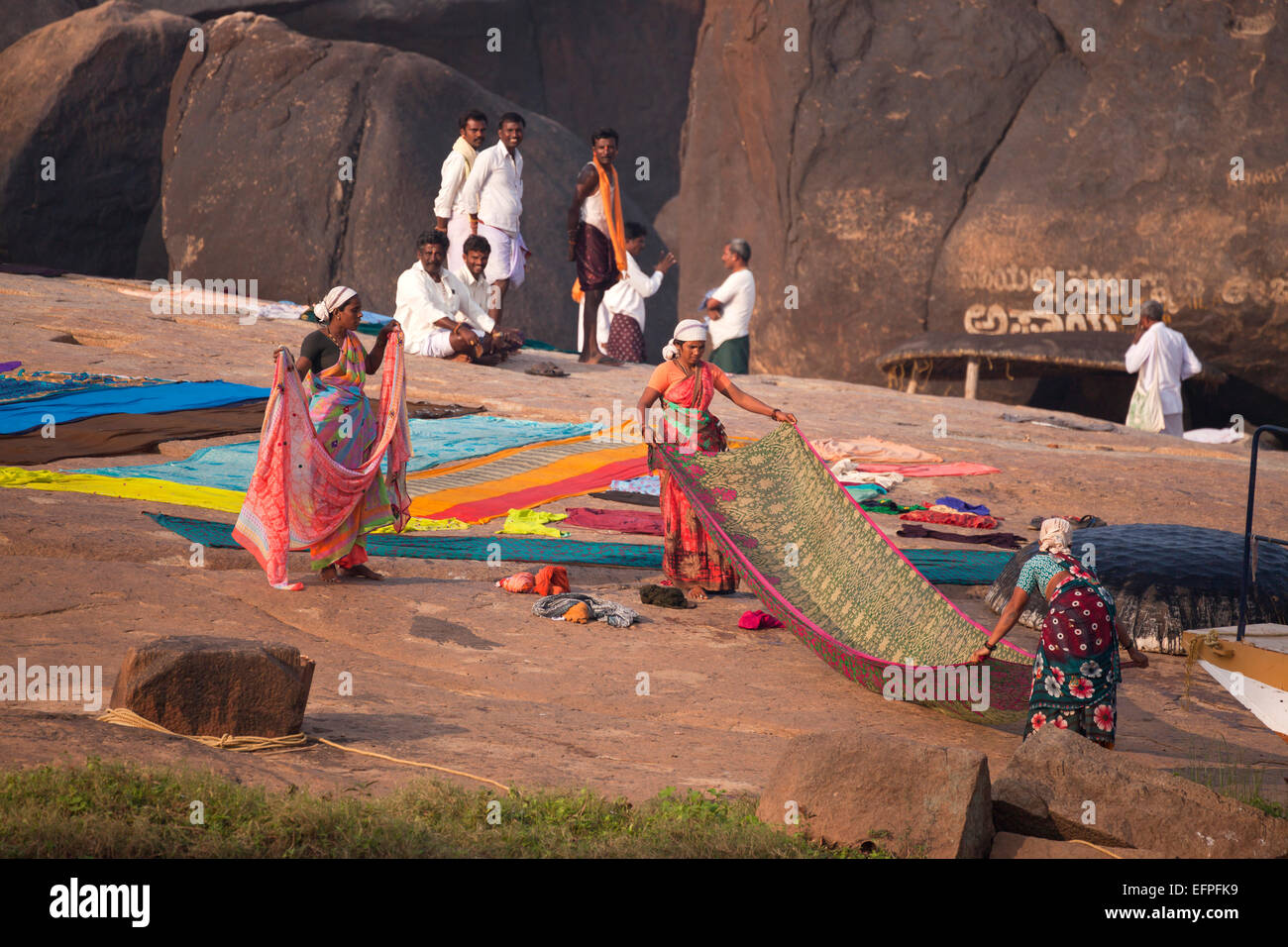woman with their laundry at the river in  Hampi, Karnataka, India, Asia Stock Photo