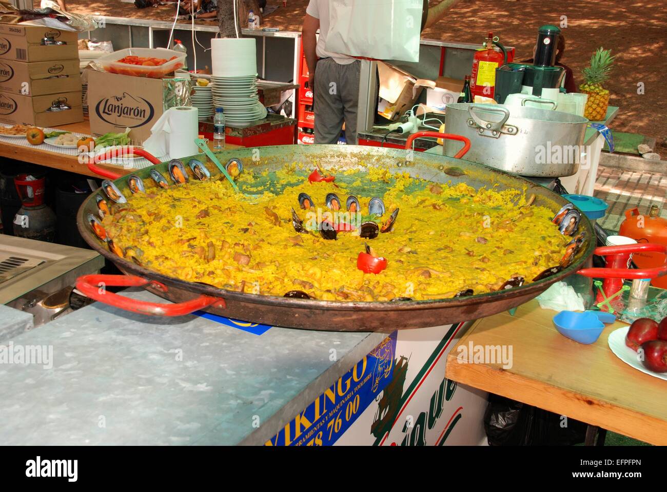 Large Paella with muscles at a snack stall during the Romeria San Bernabe festival, Marbella