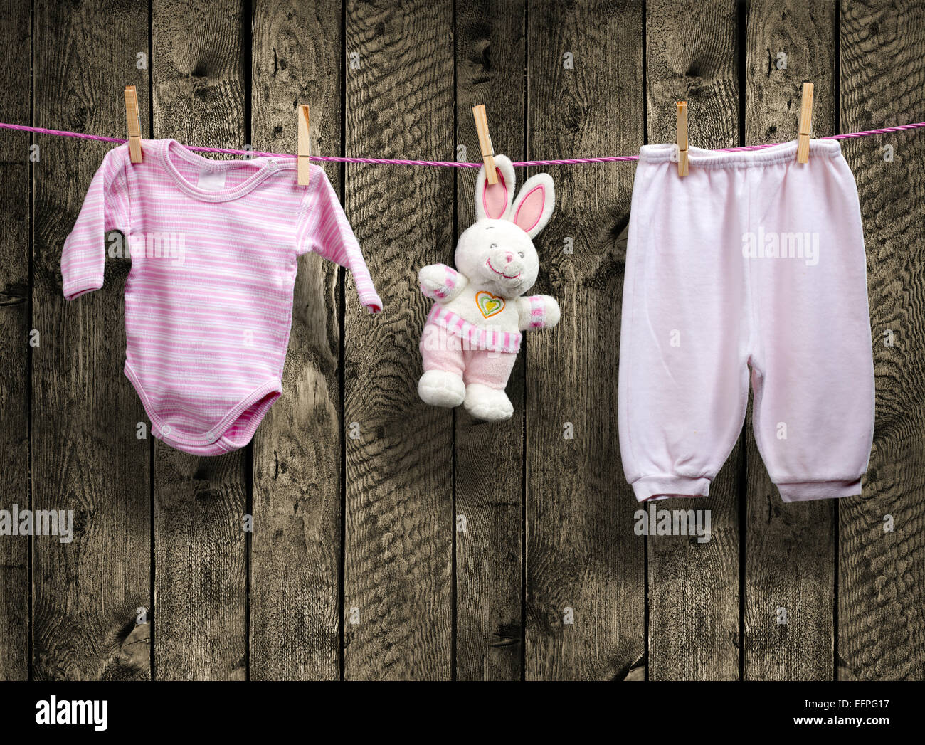 Baby girl clothes and bunny on a clothesline Stock Photo Alamy