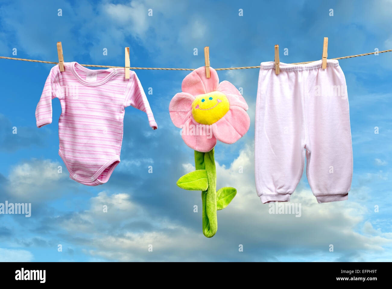 Baby girl clothes with flower  on the clothesline Stock Photo