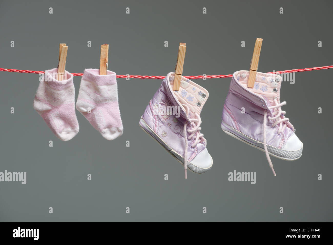 baby girl shoes and socks on the clothesline Stock Photo Alamy