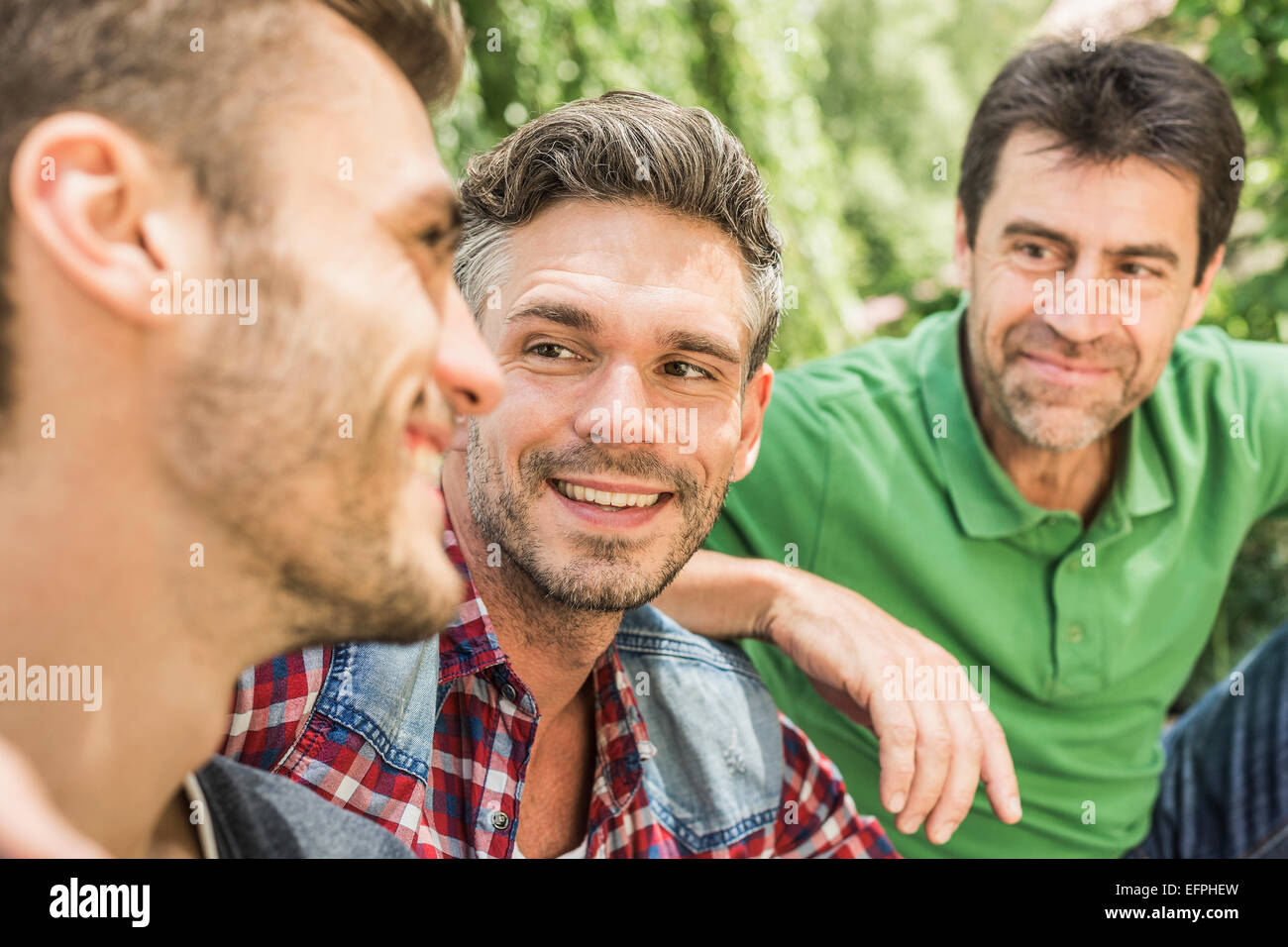 Three men, head and shoulders, looking away Stock Photo