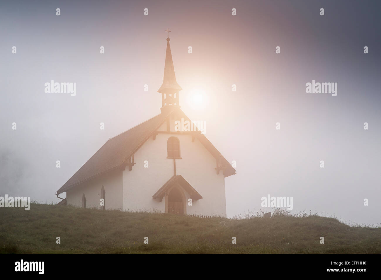 View of mist and church, Bettmeralp, Valais, Switzerland Stock Photo