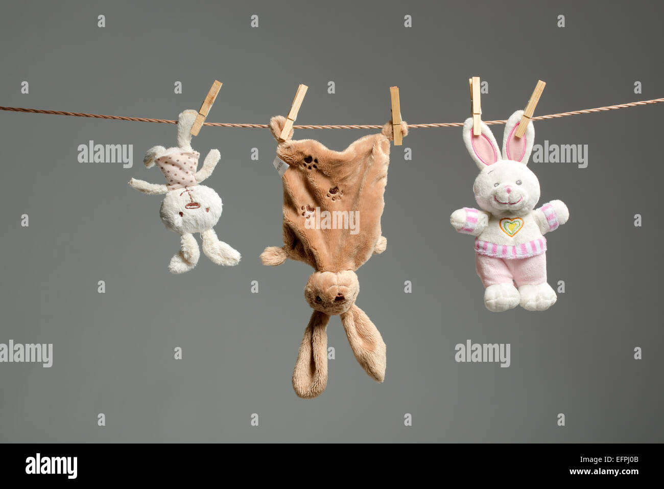 Plush bunnies on the clothesline,on gray background Stock Photo Alamy