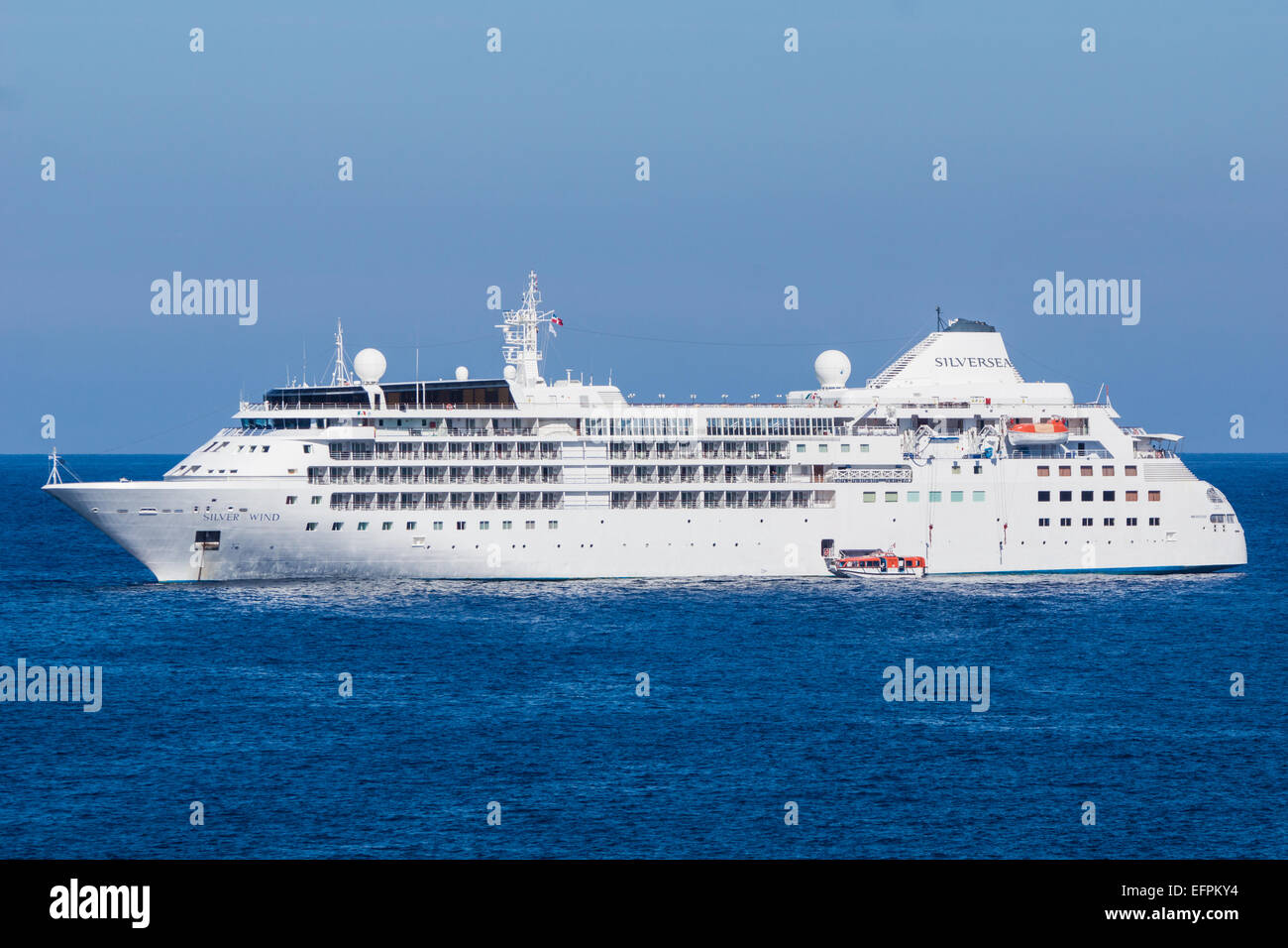 A mediterainean cruiseliner anchors up outside the bay at Port de Sollér in Mallorca and passengers get in by boat Stock Photo