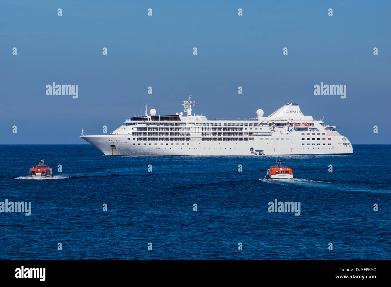 A mediterainean cruiseliner anchors up outside the bay at Port de Sollér in Mallorca and passengers get in by boat Stock Photo