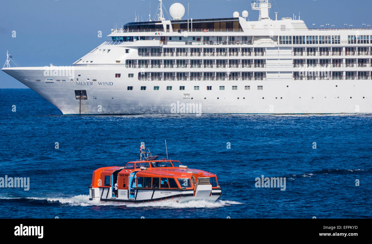 A mediterainean cruiseliner anchors up outside the bay at Port de Sollér in Mallorca and passengers get in by boat Stock Photo