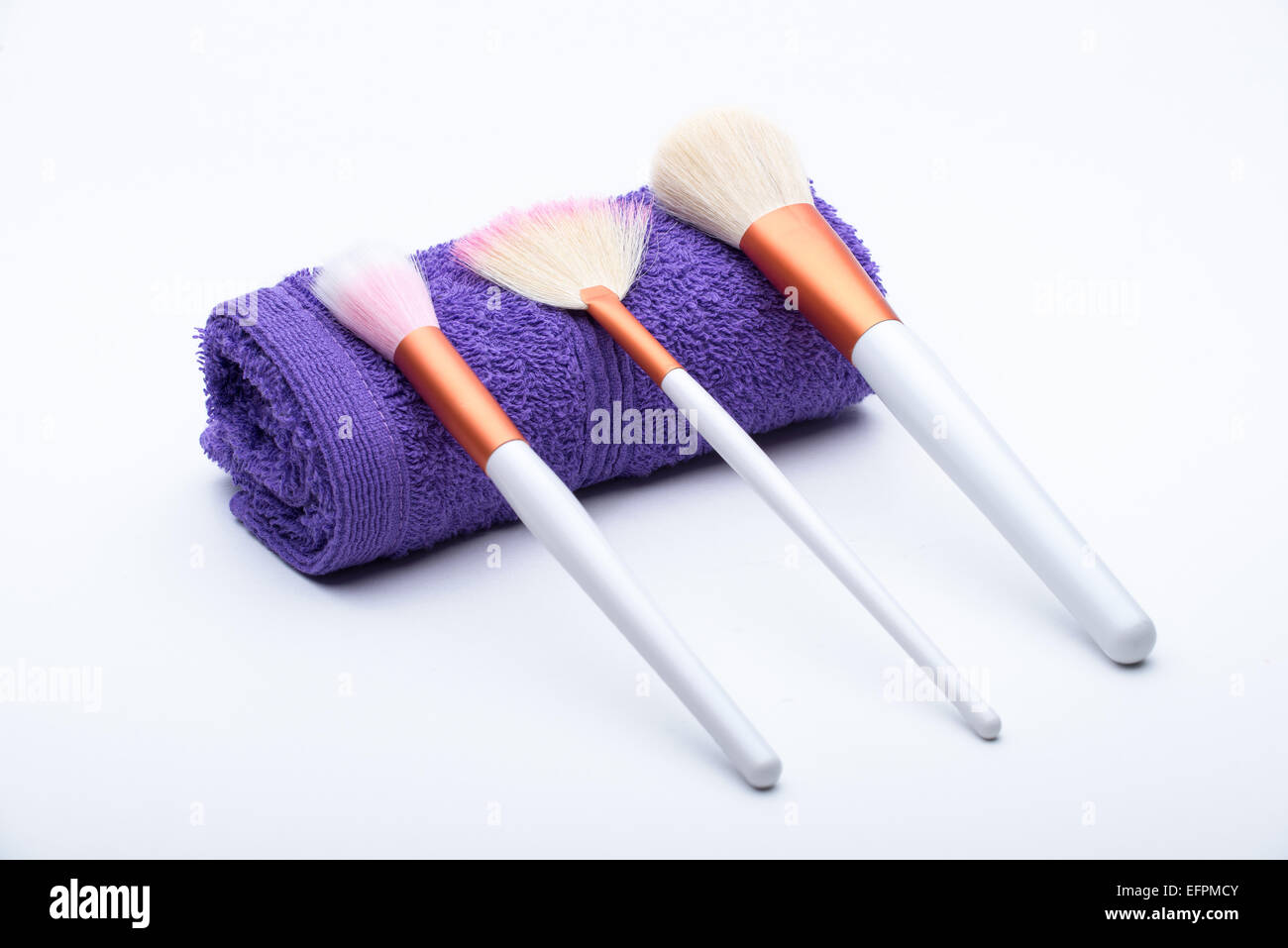Makeup Brushes on purple towel Stock Photo
