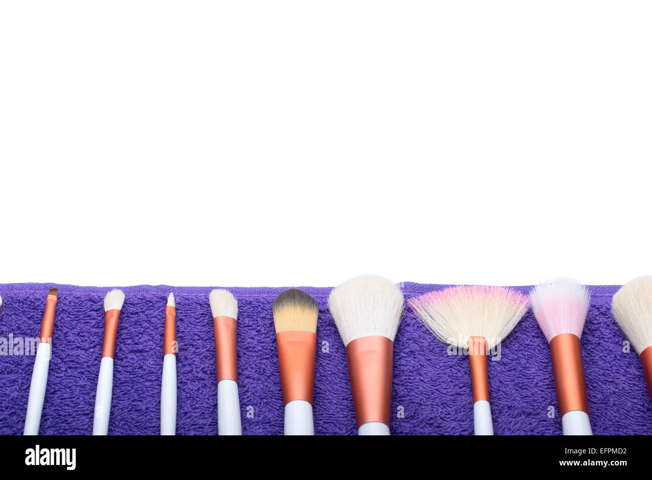 Makeup Brushes set on purple towel Stock Photo