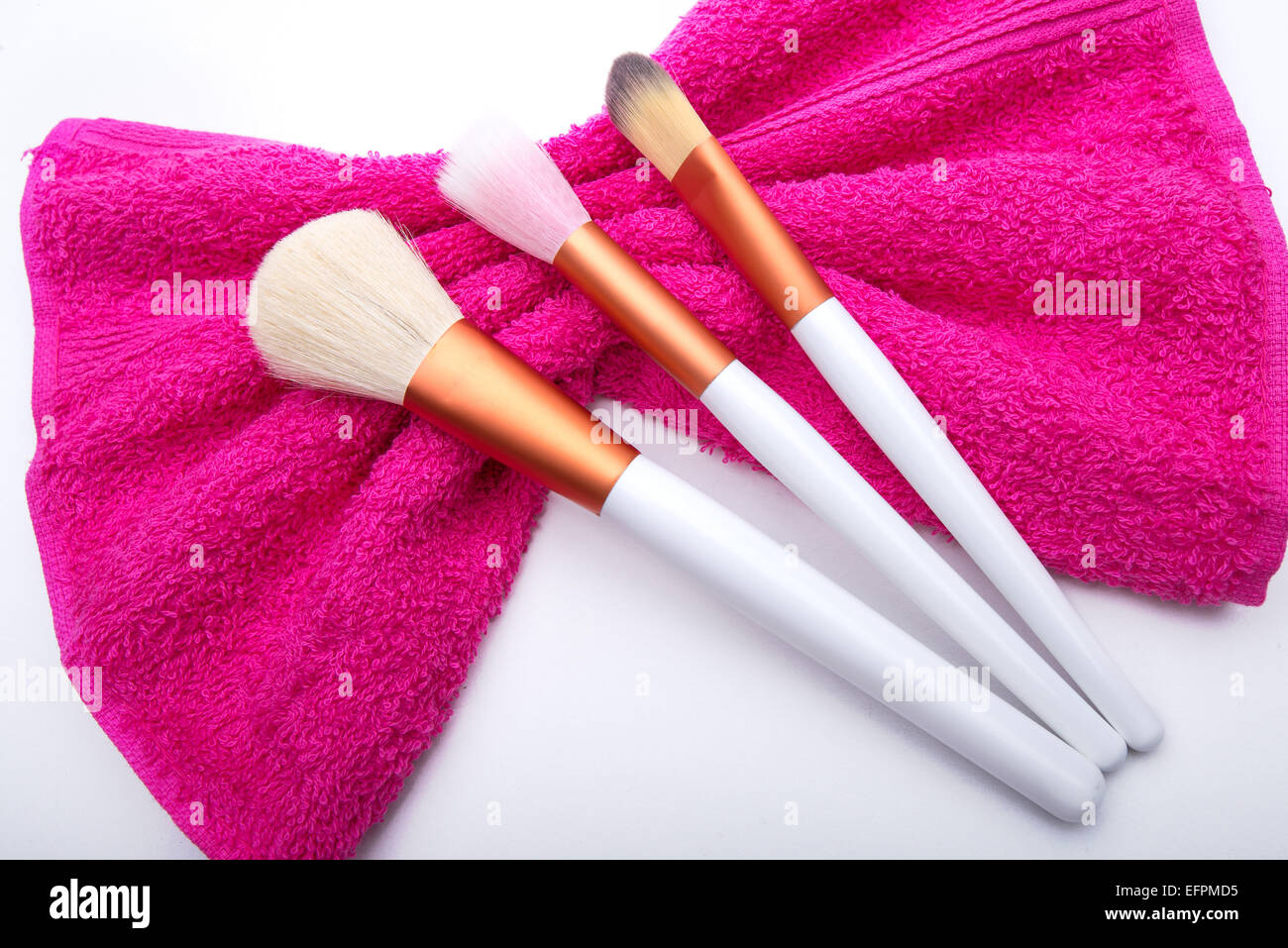 Makeup Brushes on pink  bow towel Stock Photo