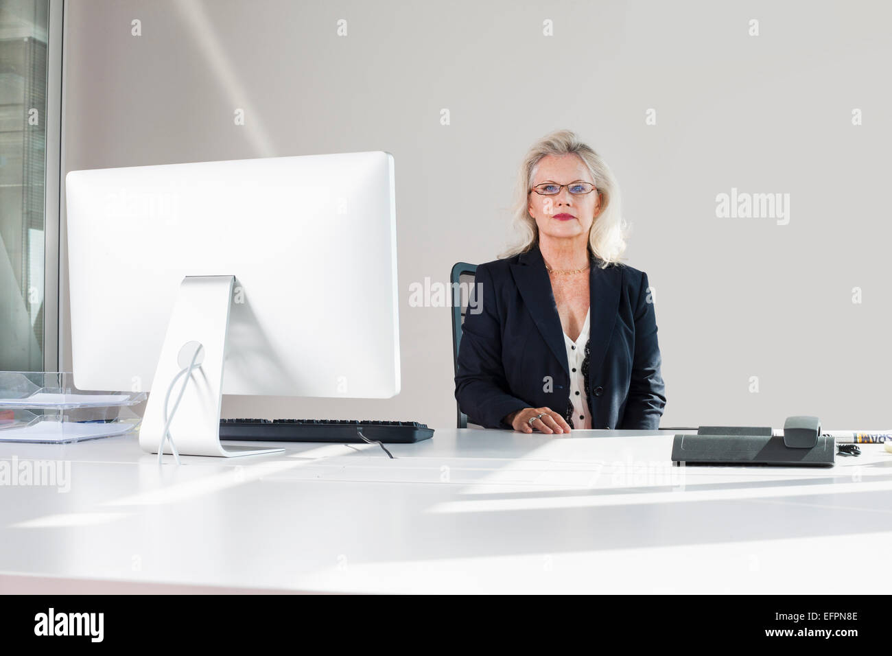 Businesswoman at desk, portrait Stock Photo