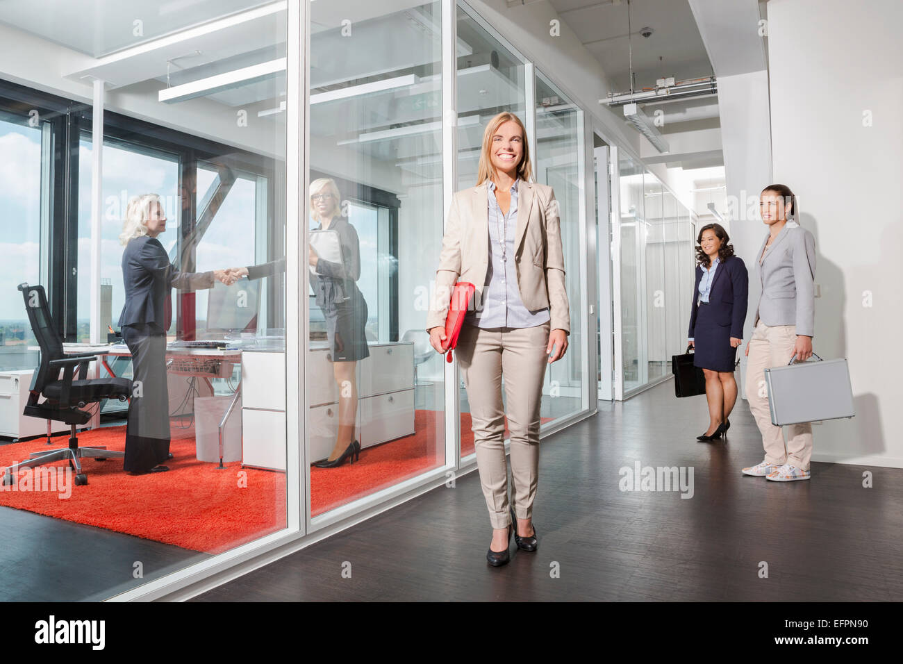 Woman standing outside interview room Stock Photo