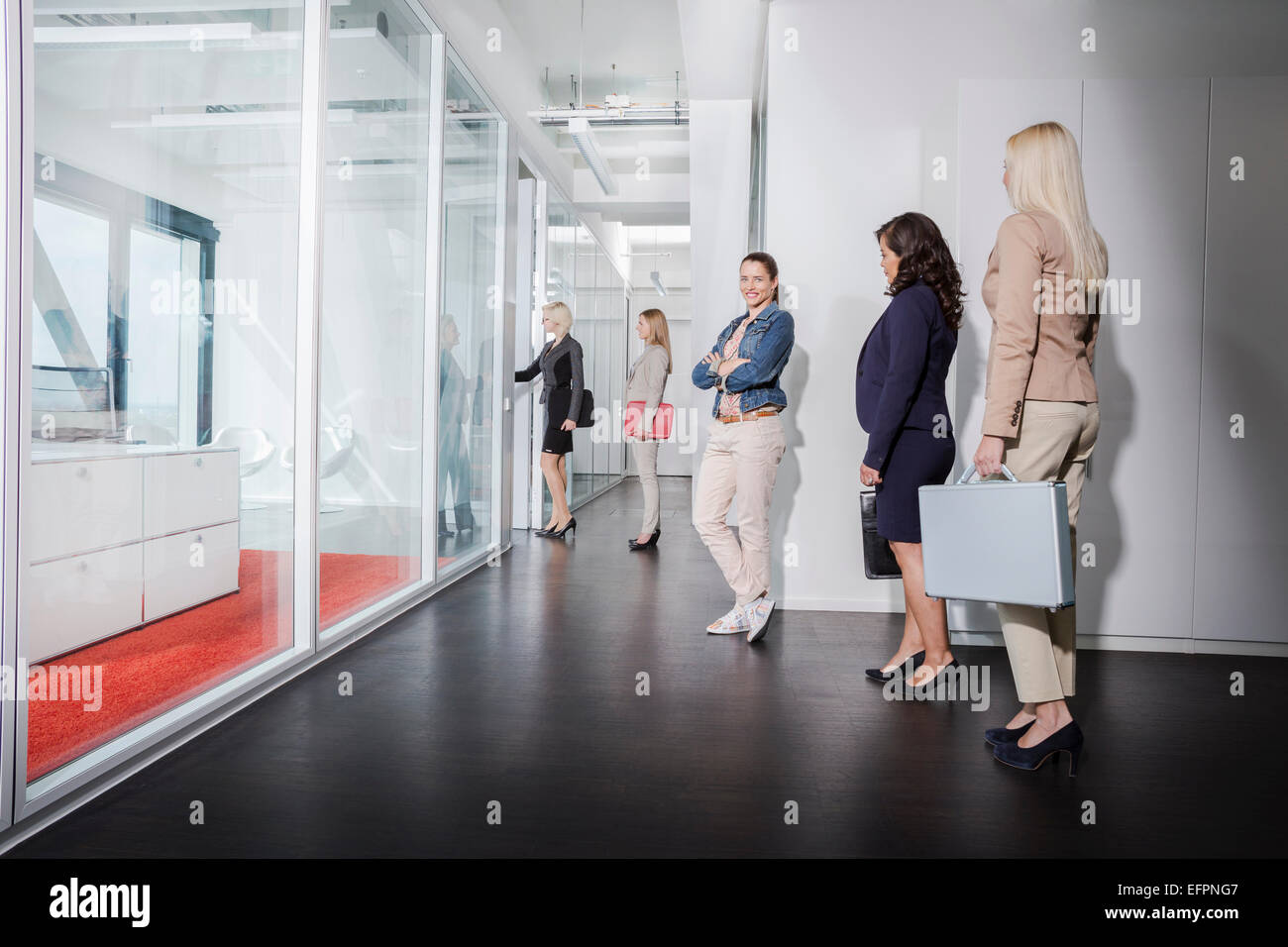 Women queueing outside interview room Stock Photo