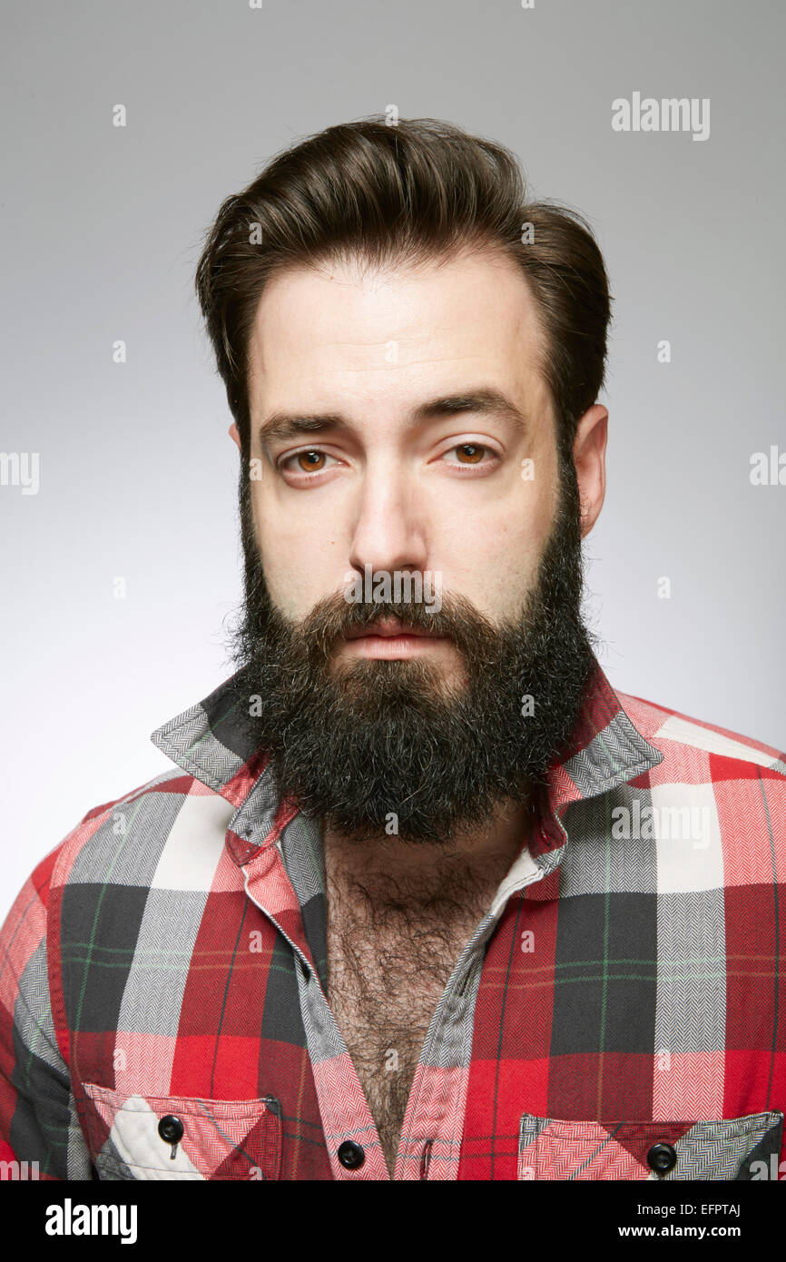 Studio portrait of aloof bearded young man Stock Photo