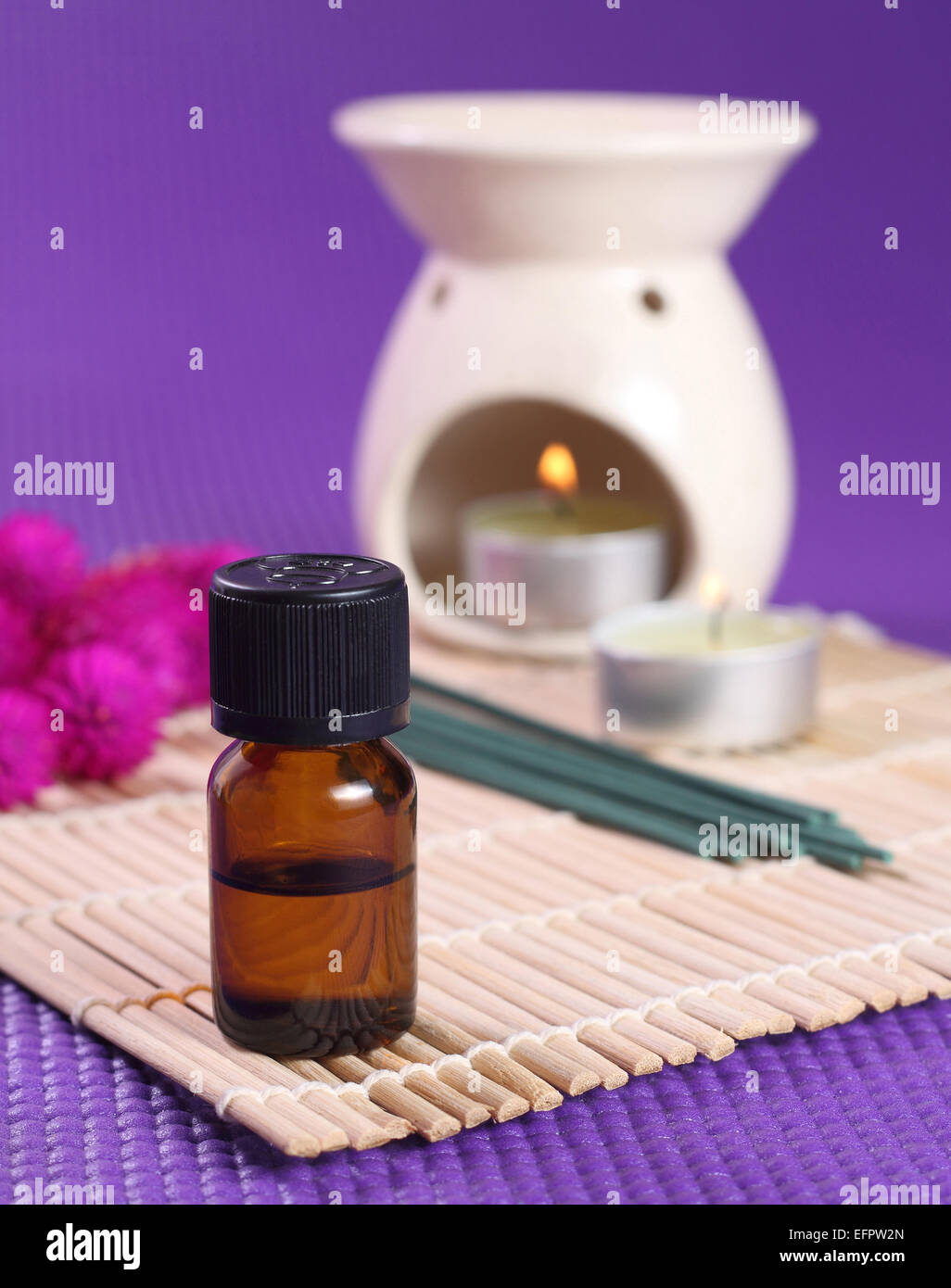 Bottle of essential oil, aromatherapy burner and candles. Let's go spa! Stock Photo