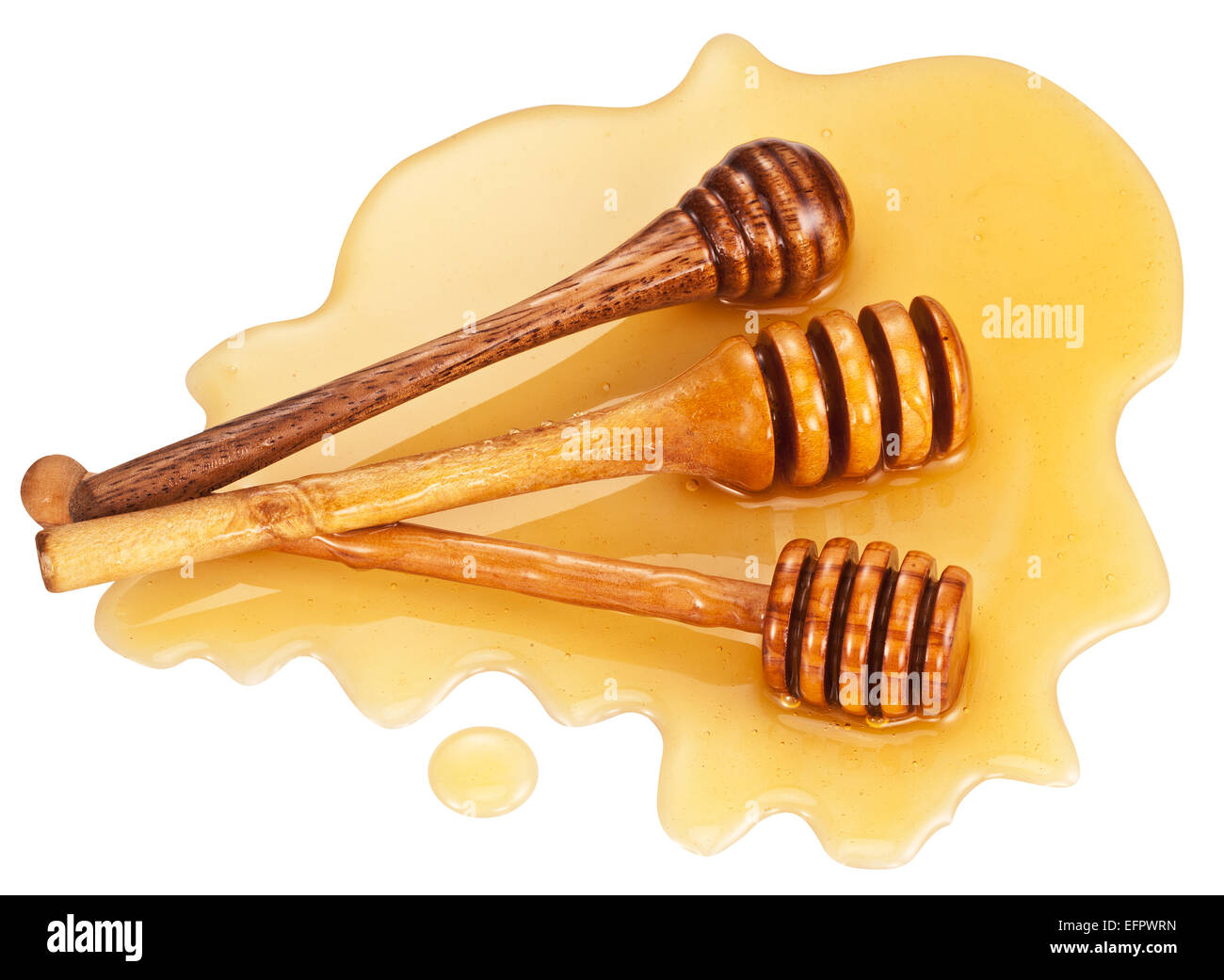 Wooden sticks lays in honey stain on white background. Clipping paths. Stock Photo
