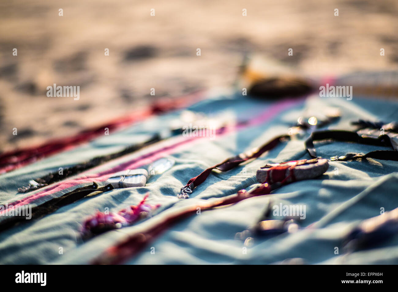 Handmade jewelry on a blanket on a beach market. Stock Photo