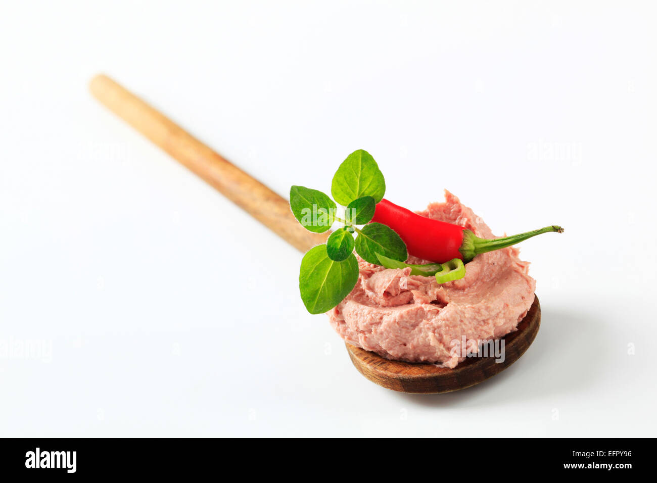 Liver pate on a wooden spoon - studio Stock Photo