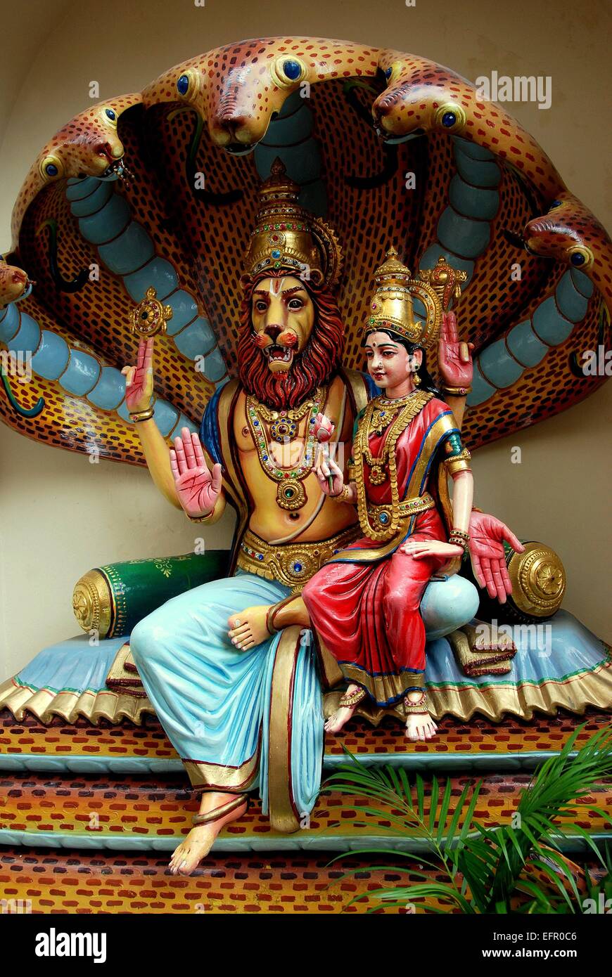 Singapore:  Lion king with Indian princess sitting beneath a cobra canopy at the Sri Krishnan Hindu Temple Stock Photo
