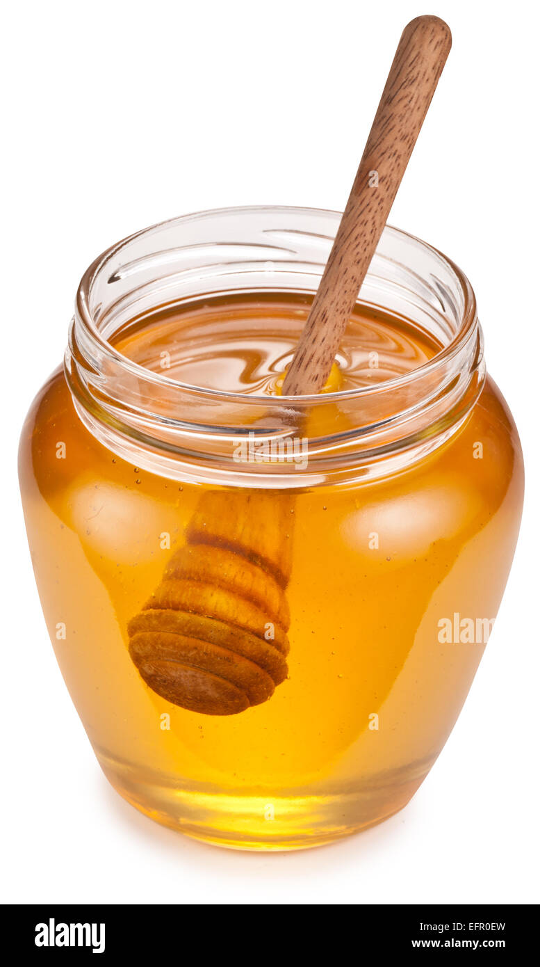 Glass can full of honey and wooden stick in it. Clipping paths. Stock Photo