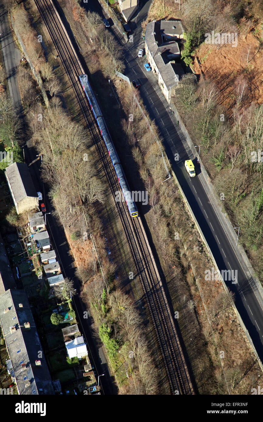 aerial view of a train on a railway track and an ambulance on a road, UK Stock Photo