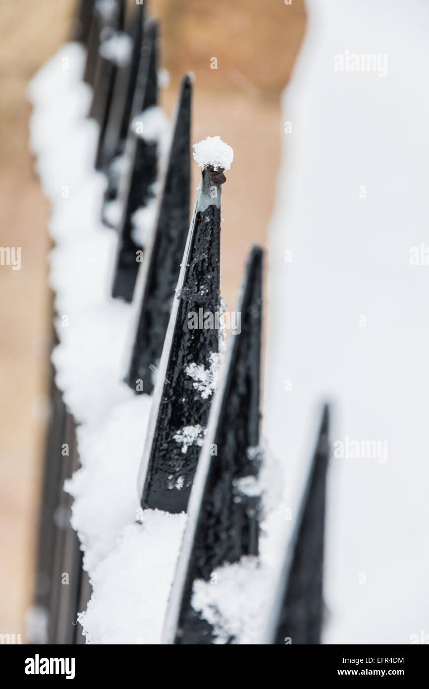 cluster of snow balanced on the sharpest point of the fence during snow ...