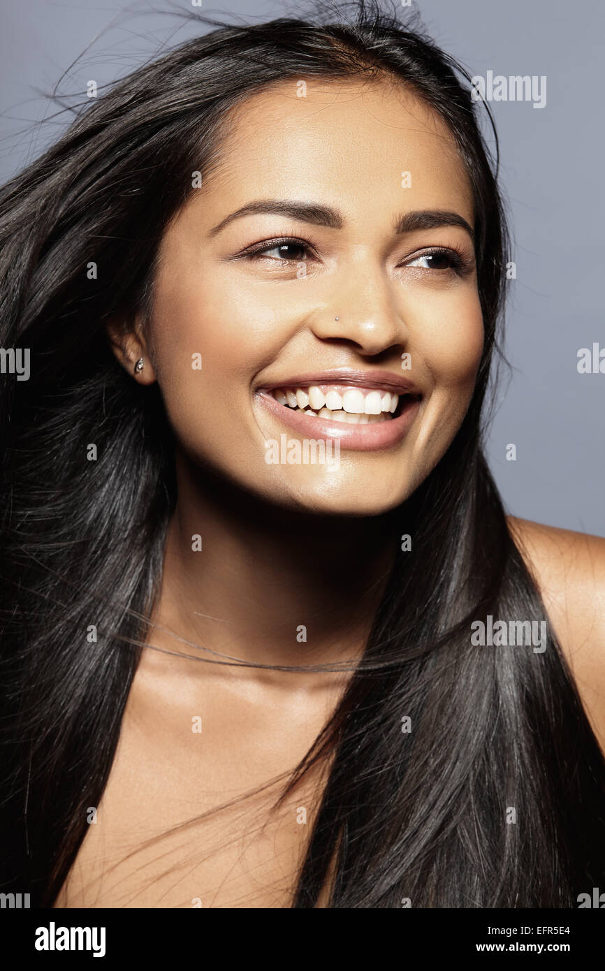 Female model smiling, looking into distance Stock Photo