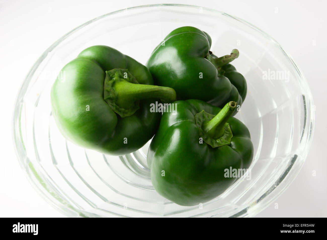 Three Green Peppers in a Glass Bowl Stock Photo