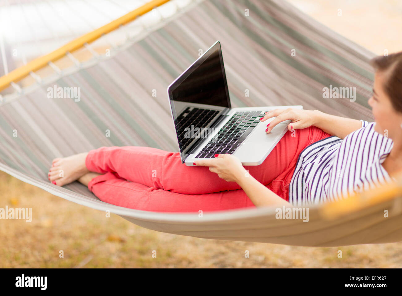 Women using laptop on hammock Stock Photo