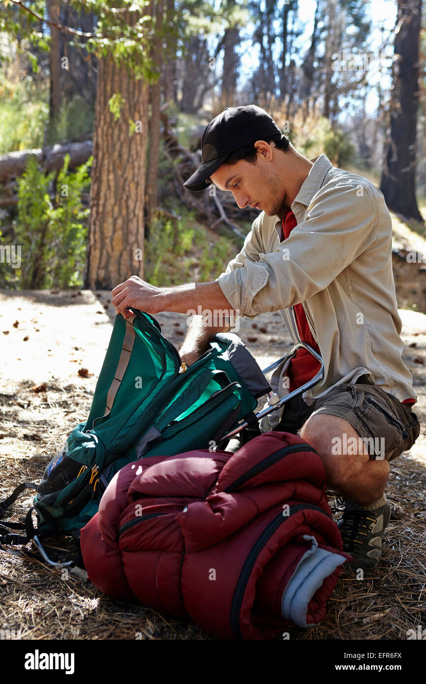 Young man in forest unpacking camping equipment, Los Angeles, California, USA Stock Photo Alamy