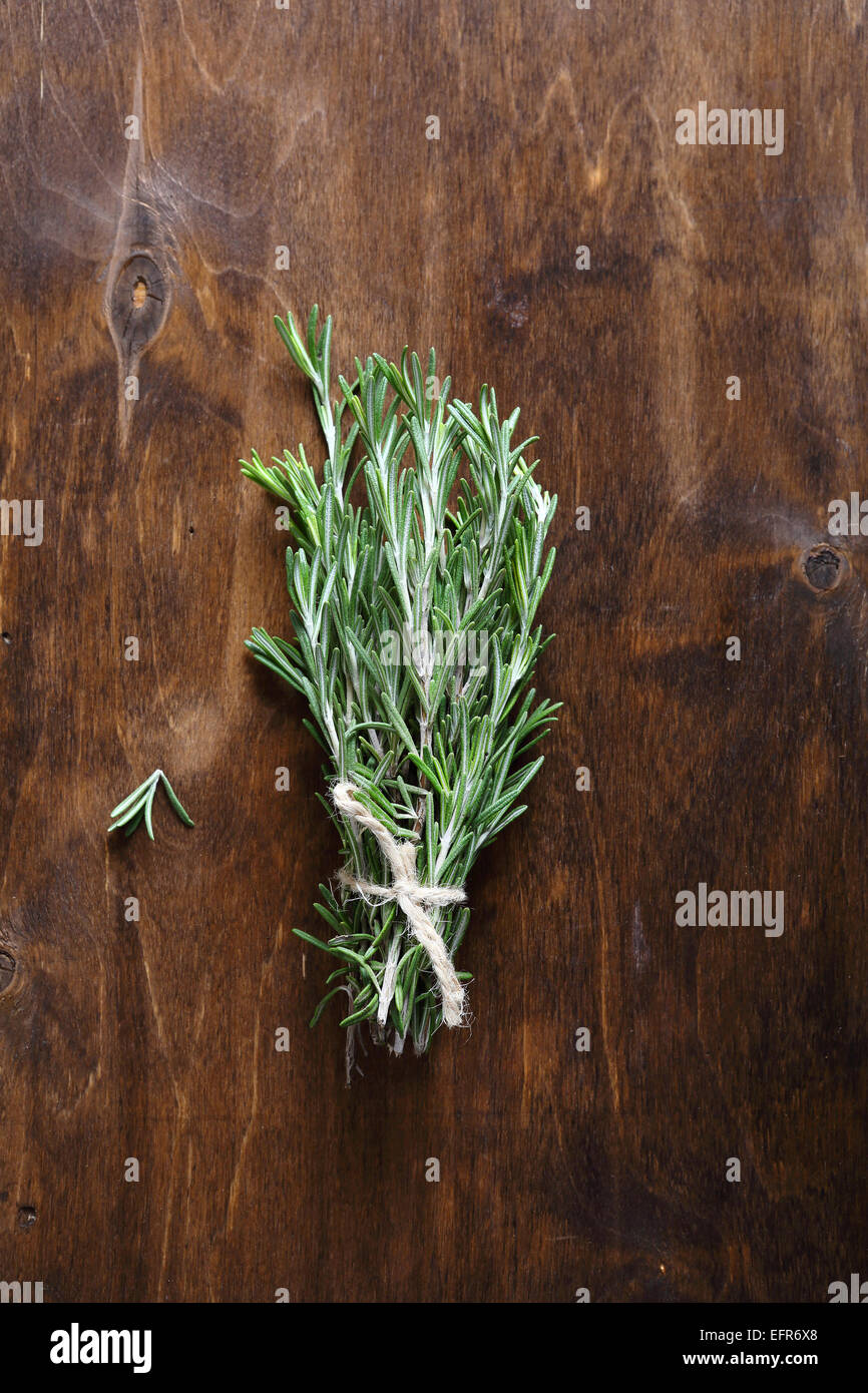 Sprigs of rosemary on the table, aroma herb Stock Photo